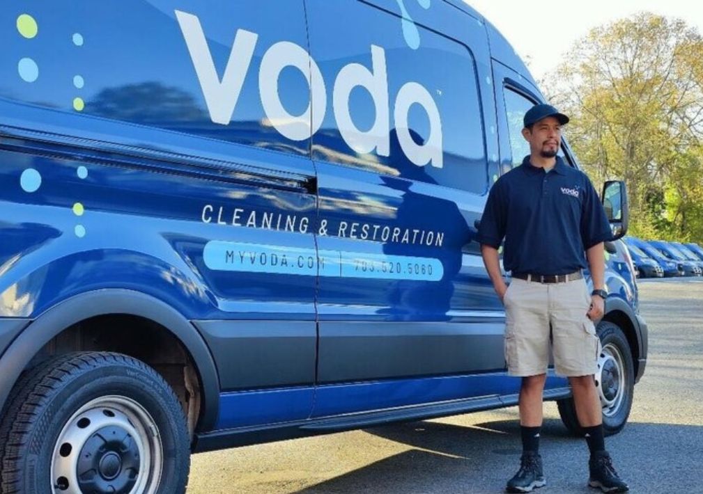 image of man infront of work van for voda cleaning services of sugar land texas.