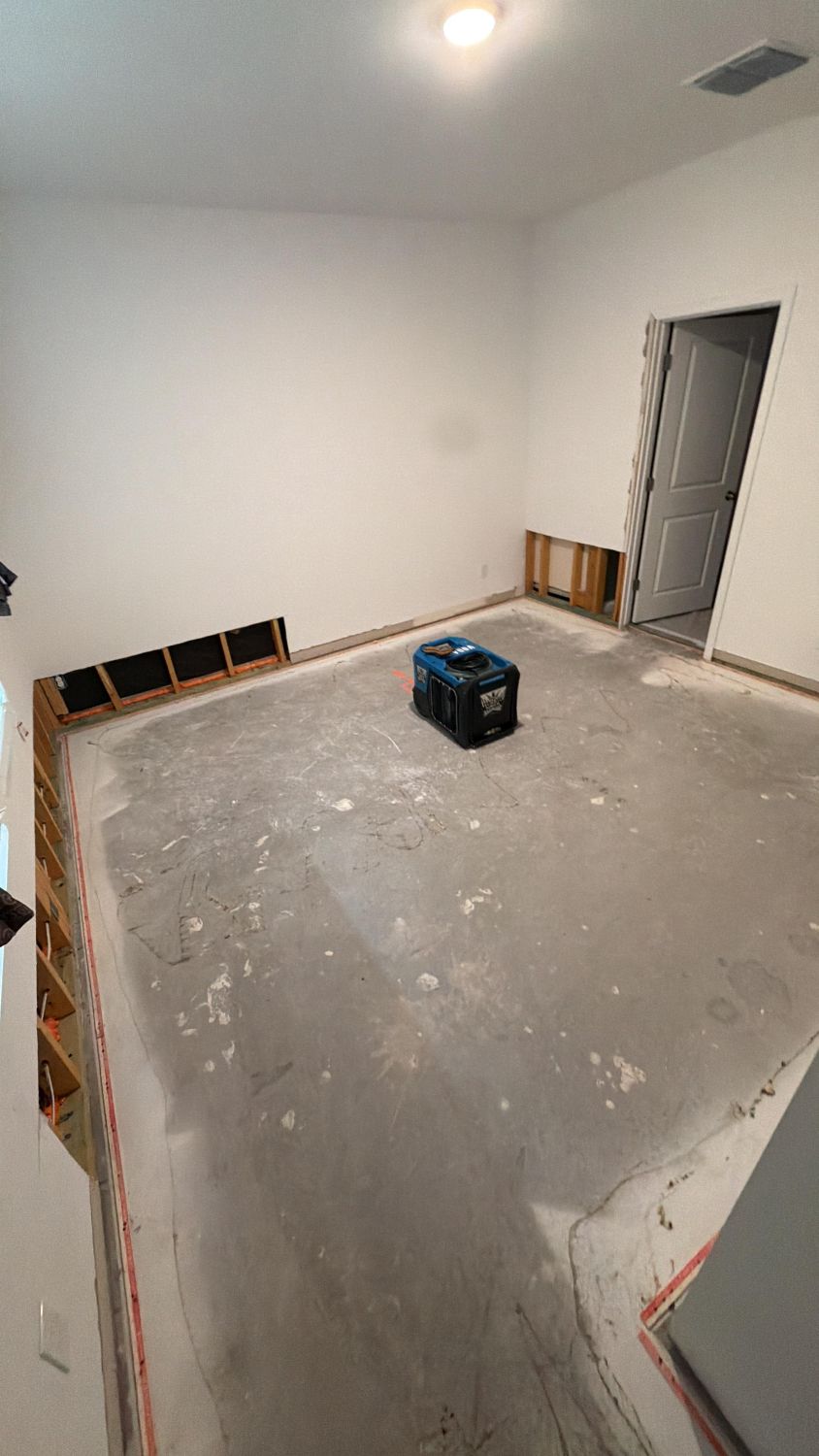 Bedroom with baseboards removed and walls dried to standard after water damage mitigation