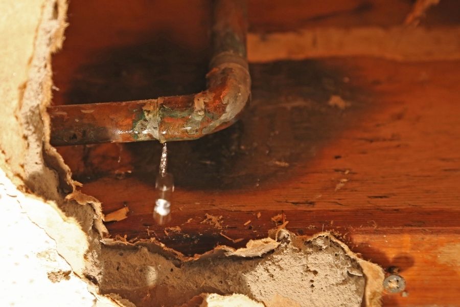 Gradual pipe leak hidden behind a wall