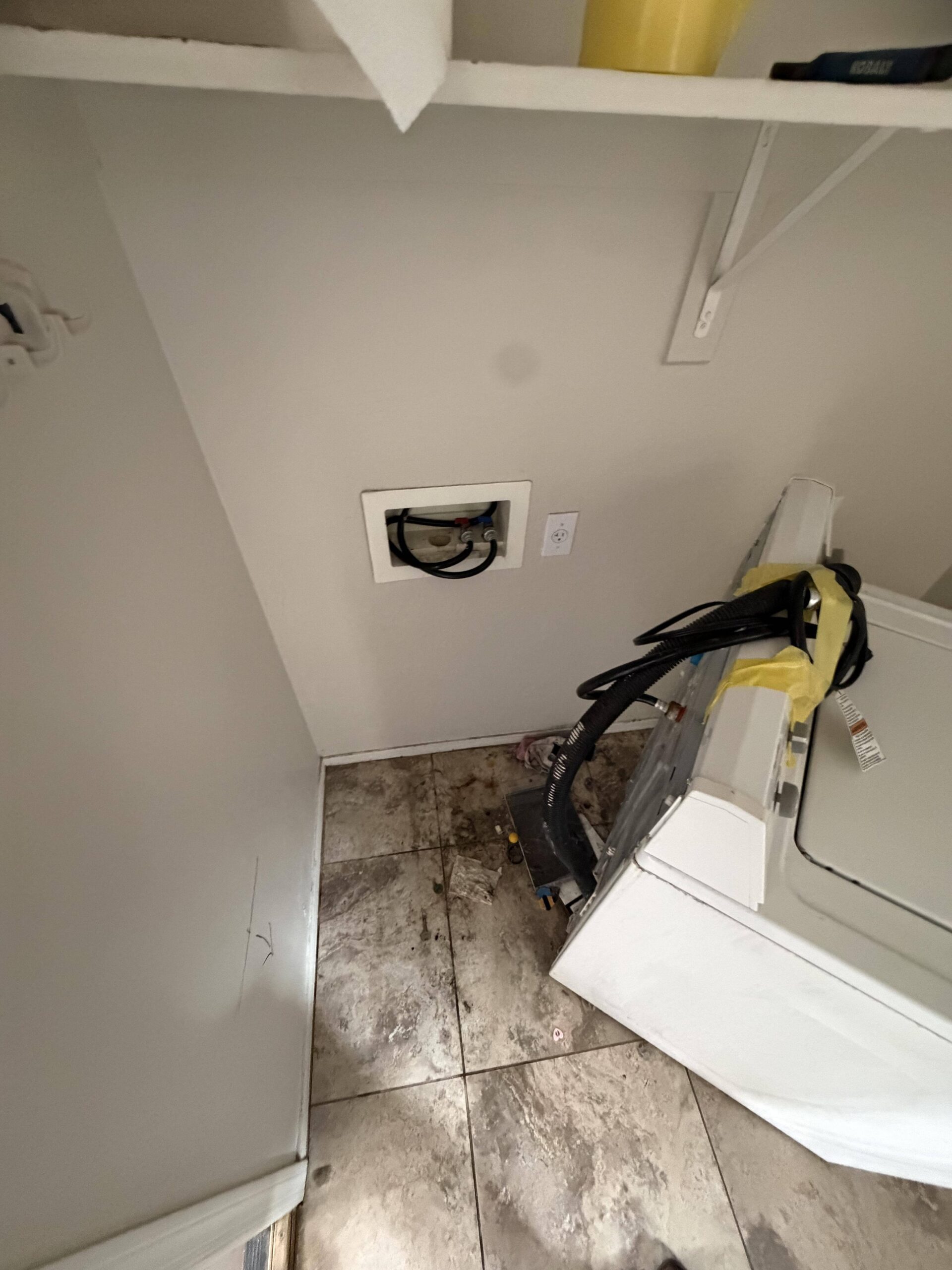 Water damage cleanup in progress in laundry room of Maricopa residence