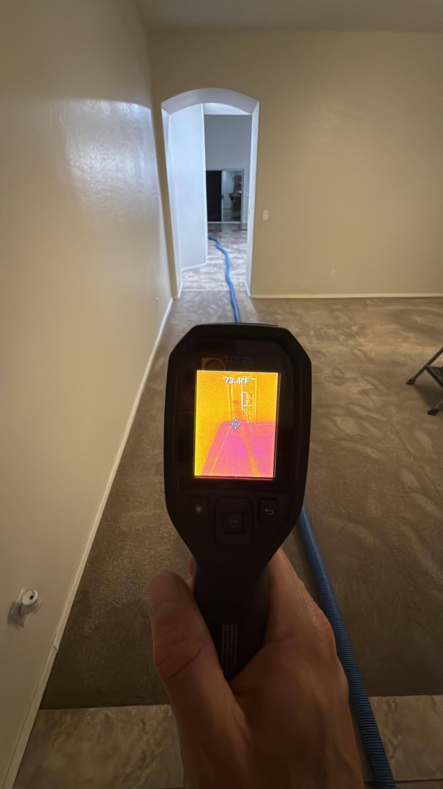 Thermal imaging camera detecting moisture behind walls during water damage inspection