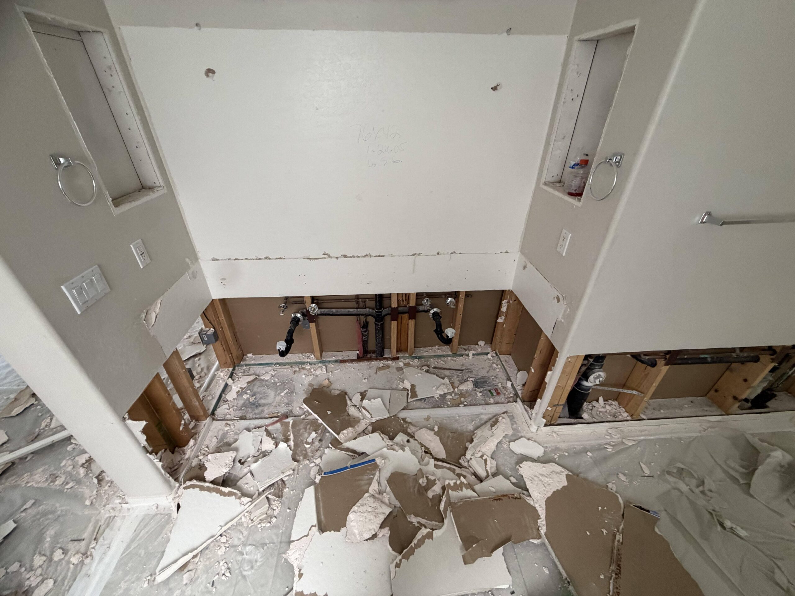Two-foot flood cut drywall demolition exposing wall framing for drying