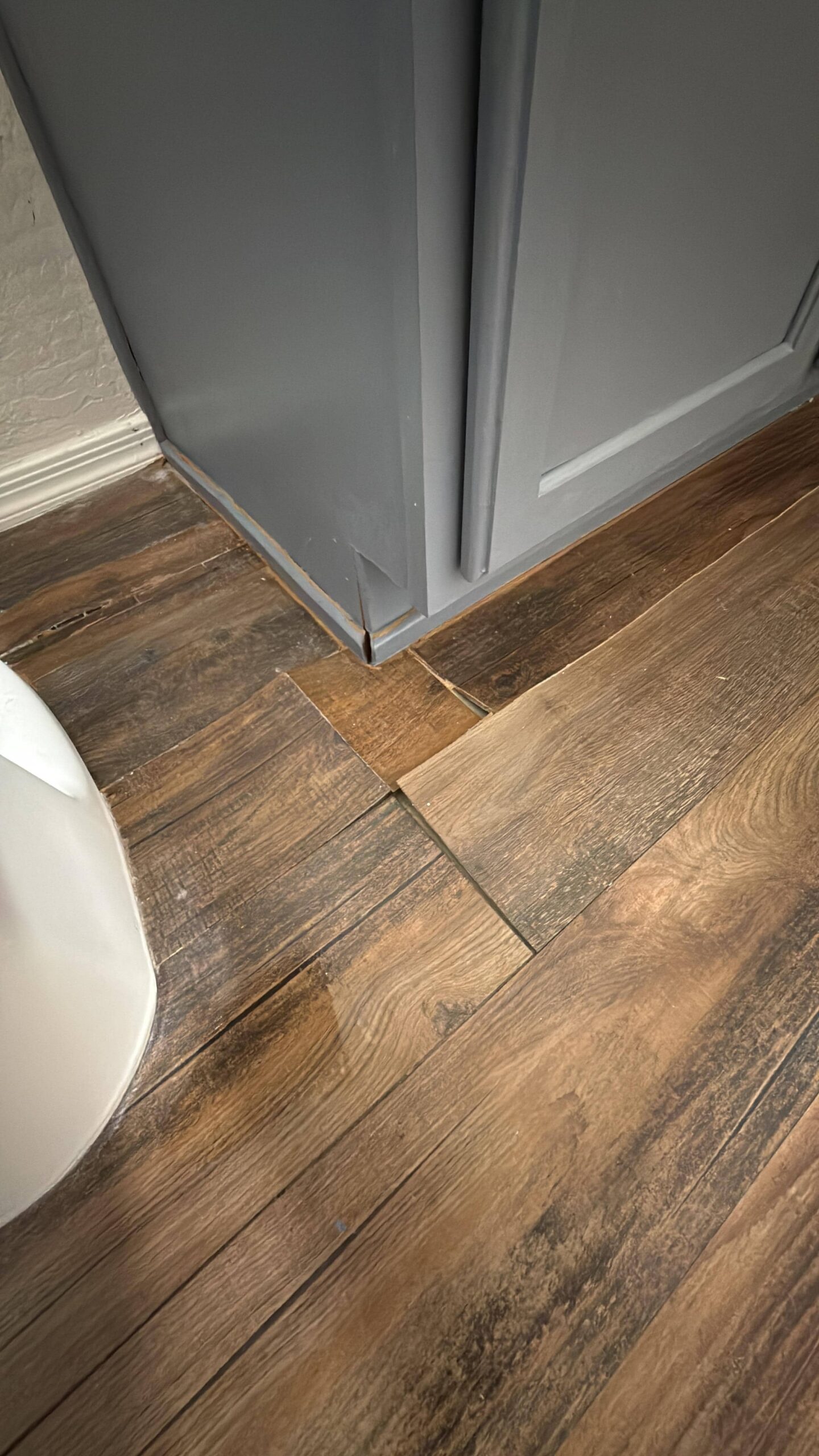 Water-damaged flooring showing saturation and discoloration in residential home